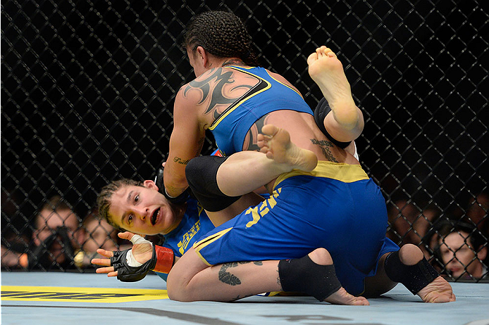 LAS VEGAS, NV - NOVEMBER 30:  (R-L) Raquel Pennington controls Roxanne Modafferi in their women's bantamweight fight during The Ultimate Fighter season 18 live finale inside the Mandalay Bay Events Center on November 30, 2013 in Las Vegas, Nevada. (Photo 