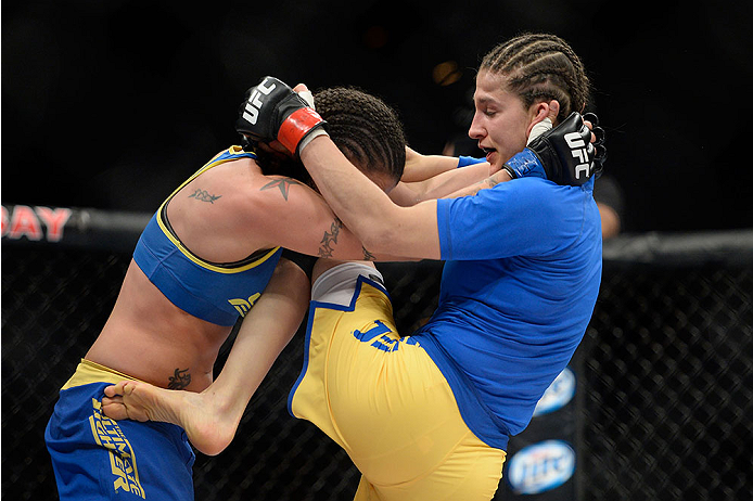 LAS VEGAS, NV - NOVEMBER 30:  (R-L) Roxanne Modafferi lands a knee to the body of Raquel Pennington in their women's bantamweight fight during The Ultimate Fighter season 18 live finale inside the Mandalay Bay Events Center on November 30, 2013 in Las Veg