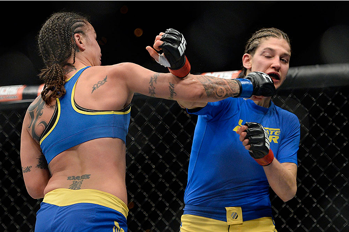 LAS VEGAS, NV - NOVEMBER 30: (L-R) Raquel Pennington punches Roxanne Modafferi in their women's bantamweight fight during The Ultimate Fighter season 18 live finale inside the Mandalay Bay Events Center on November 30, 2013 in Las Vegas, Nevada. (Photo b