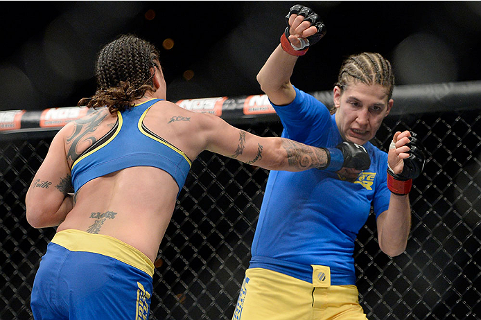 LAS VEGAS, NV - NOVEMBER 30: (L-R) Raquel Pennington punches Roxanne Modafferi in their women's bantamweight fight during The Ultimate Fighter season 18 live finale inside the Mandalay Bay Events Center on November 30, 2013 in Las Vegas, Nevada. (Photo b