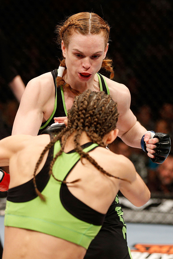 LAS VEGAS, NV - NOVEMBER 30: Peggy Morgan (black shorts) punches Jessamyn Duke in their women's bantamweight fight during The Ultimate Fighter season 18 live finale inside the Mandalay Bay Events Center on November 30, 2013 in Las Vegas, Nevada. (Photo b