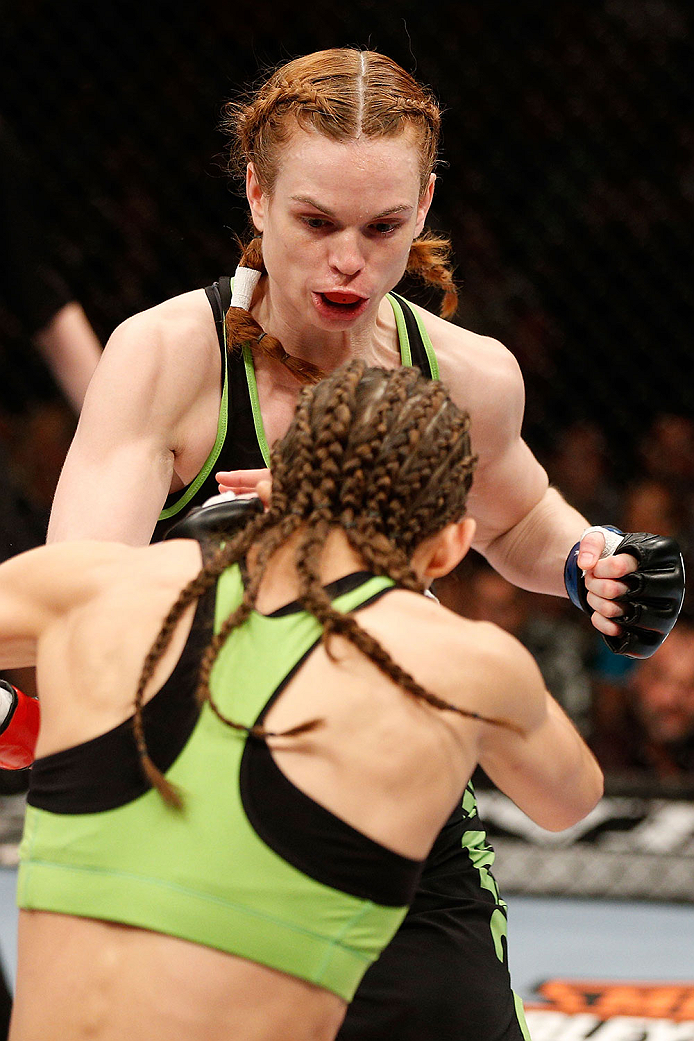 LAS VEGAS, NV - NOVEMBER 30:  Peggy Morgan (black shorts) punches Jessamyn Duke in their women's bantamweight fight during The Ultimate Fighter season 18 live finale inside the Mandalay Bay Events Center on November 30, 2013 in Las Vegas, Nevada. (Photo b