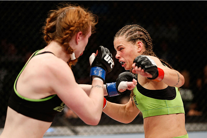 LAS VEGAS, NV - NOVEMBER 30:  (L-R) Peggy Morgan punches Jessamyn Duke in their women's bantamweight fight during The Ultimate Fighter season 18 live finale inside the Mandalay Bay Events Center on November 30, 2013 in Las Vegas, Nevada. (Photo by Josh He