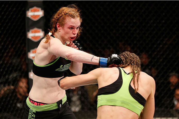 LAS VEGAS, NV - NOVEMBER 30:  (L-R) Peggy Morgan punches Jessamyn Duke in their women's bantamweight fight during The Ultimate Fighter season 18 live finale inside the Mandalay Bay Events Center on November 30, 2013 in Las Vegas, Nevada. (Photo by Josh He