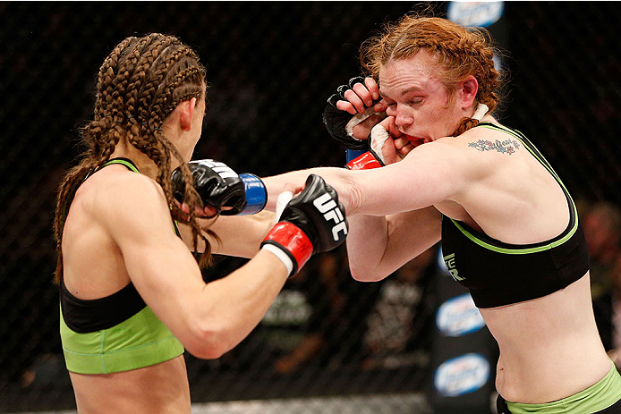 LAS VEGAS, NV - NOVEMBER 30:  (L-R) Jessamyn Duke punches Peggy Morgan in their women's bantamweight fight during The Ultimate Fighter season 18 live finale inside the Mandalay Bay Events Center on November 30, 2013 in Las Vegas, Nevada. (Photo by Josh He