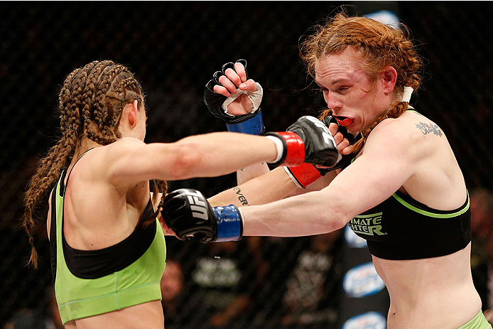 LAS VEGAS, NV - NOVEMBER 30: (L-R) Jessamyn Duke punches Peggy Morgan in their women's bantamweight fight during The Ultimate Fighter season 18 live finale inside the Mandalay Bay Events Center on November 30, 2013 in Las Vegas, Nevada. (Photo by Josh He