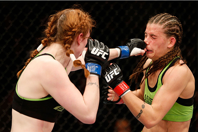 LAS VEGAS, NV - NOVEMBER 30:  (L-R) Peggy Morgan punches Jessamyn Duke in their women's bantamweight fight during The Ultimate Fighter season 18 live finale inside the Mandalay Bay Events Center on November 30, 2013 in Las Vegas, Nevada. (Photo by Josh He