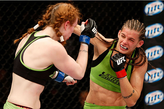 LAS VEGAS, NV - NOVEMBER 30: (R-L) Jessamyn Duke punches Peggy Morgan in their women's bantamweight fight during The Ultimate Fighter season 18 live finale inside the Mandalay Bay Events Center on November 30, 2013 in Las Vegas, Nevada. (Photo by Josh He