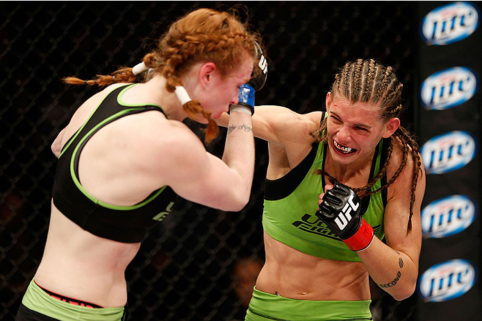 LAS VEGAS, NV - NOVEMBER 30:  (R-L) Jessamyn Duke punches Peggy Morgan in their women's bantamweight fight during The Ultimate Fighter season 18 live finale inside the Mandalay Bay Events Center on November 30, 2013 in Las Vegas, Nevada. (Photo by Josh He