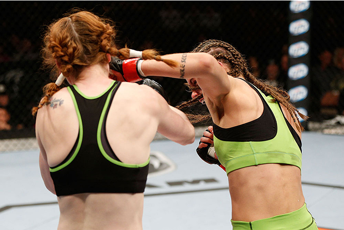 LAS VEGAS, NV - NOVEMBER 30:  (R-L) Jessamyn Duke punches Peggy Morgan in their women's bantamweight fight during The Ultimate Fighter season 18 live finale inside the Mandalay Bay Events Center on November 30, 2013 in Las Vegas, Nevada. (Photo by Josh He