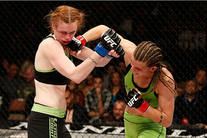 LAS VEGAS, NV - NOVEMBER 30:  (R-L) Jessamyn Duke punches Peggy Morgan in their women's bantamweight fight during The Ultimate Fighter season 18 live finale inside the Mandalay Bay Events Center on November 30, 2013 in Las Vegas, Nevada. (Photo by Josh He