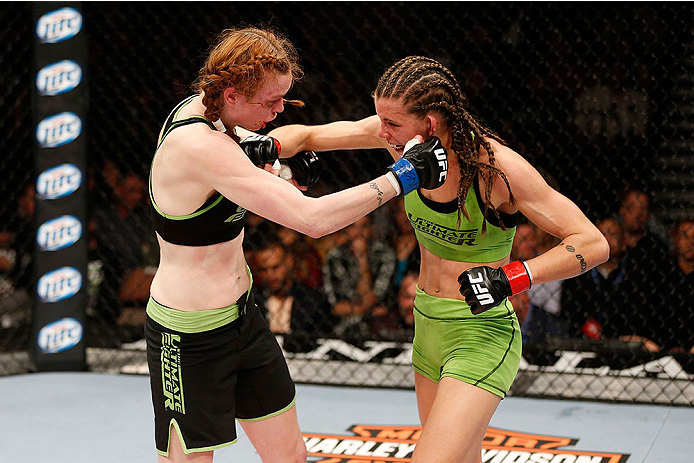 LAS VEGAS, NV - NOVEMBER 30:  (R-L) Jessamyn Duke punches Peggy Morgan in their women's bantamweight fight during The Ultimate Fighter season 18 live finale inside the Mandalay Bay Events Center on November 30, 2013 in Las Vegas, Nevada. (Photo by Josh He