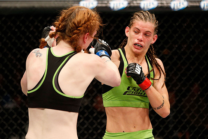 LAS VEGAS, NV - NOVEMBER 30:  (R-L) Jessamyn Duke punches Peggy Morgan in their women's bantamweight fight during The Ultimate Fighter season 18 live finale inside the Mandalay Bay Events Center on November 30, 2013 in Las Vegas, Nevada. (Photo by Josh He