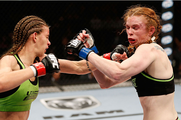 LAS VEGAS, NV - NOVEMBER 30:  (L-R) Jessamyn Duke punches Peggy Morgan in their women's bantamweight fight during The Ultimate Fighter season 18 live finale inside the Mandalay Bay Events Center on November 30, 2013 in Las Vegas, Nevada. (Photo by Josh He