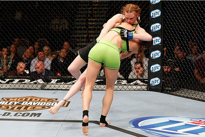 LAS VEGAS, NV - NOVEMBER 30:  Jessamyn Duke (green shorts) takes down Peggy Morgan in their women's bantamweight fight during The Ultimate Fighter season 18 live finale inside the Mandalay Bay Events Center on November 30, 2013 in Las Vegas, Nevada. (Phot