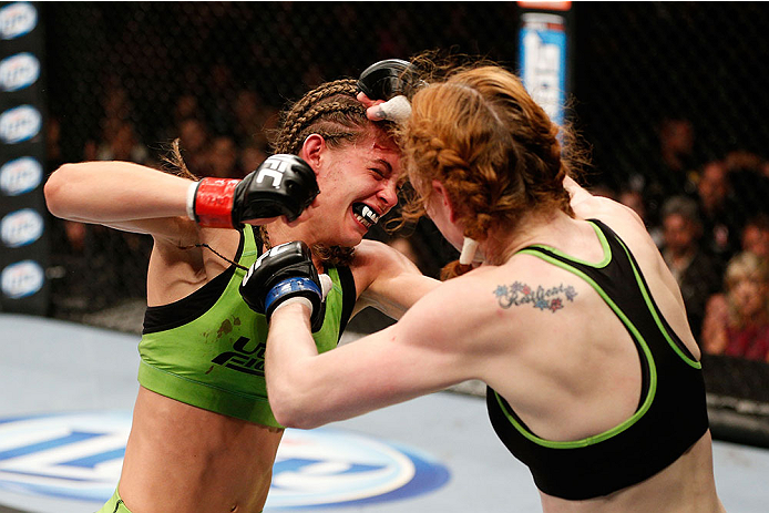 LAS VEGAS, NV - NOVEMBER 30:  (L-R) Jessamyn Duke punches Peggy Morgan in their women's bantamweight fight during The Ultimate Fighter season 18 live finale inside the Mandalay Bay Events Center on November 30, 2013 in Las Vegas, Nevada. (Photo by Josh He