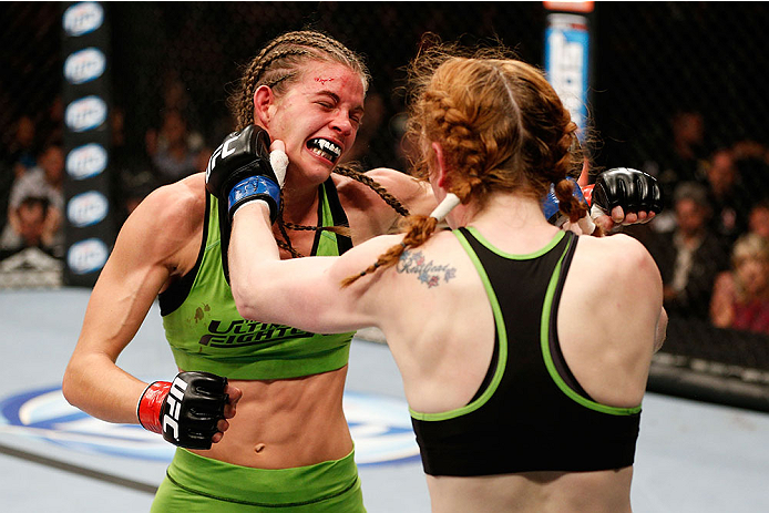 LAS VEGAS, NV - NOVEMBER 30:  (L-R) Jessamyn Duke exchanges punches with Peggy Morgan in their women's bantamweight fight during The Ultimate Fighter season 18 live finale inside the Mandalay Bay Events Center on November 30, 2013 in Las Vegas, Nevada. (P