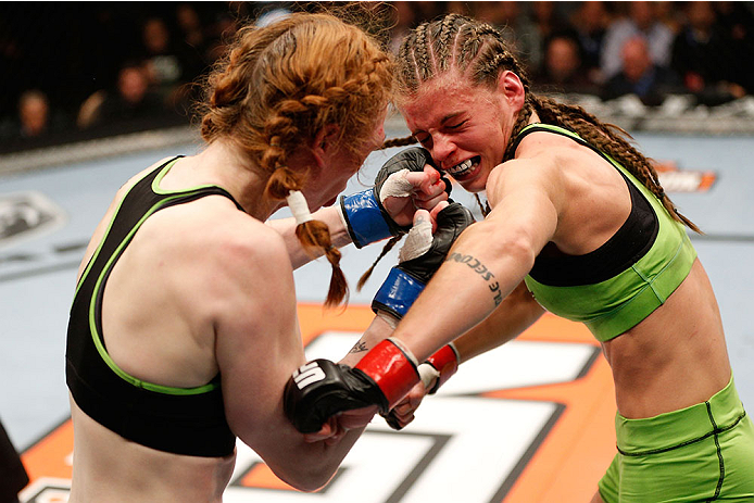 LAS VEGAS, NV - NOVEMBER 30:  (L-R) Peggy Morgan punches Jessamyn Duke in their women's bantamweight fight during The Ultimate Fighter season 18 live finale inside the Mandalay Bay Events Center on November 30, 2013 in Las Vegas, Nevada. (Photo by Josh He