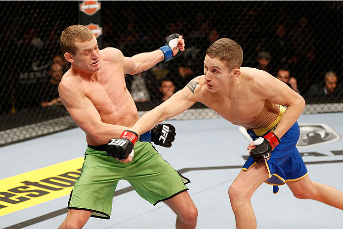 LAS VEGAS, NV - NOVEMBER 30: (R-L) Chris Holdsworth punches David Grant in their bantamweight final fight during The Ultimate Fighter season 18 live finale inside the Mandalay Bay Events Center on November 30, 2013 in Las Vegas, Nevada. (Photo by Josh He