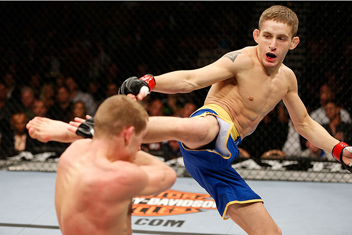 LAS VEGAS, NV - NOVEMBER 30:  (R-L) Chris Holdsworth kicks David Grant in their bantamweight final fight during The Ultimate Fighter season 18 live finale inside the Mandalay Bay Events Center on November 30, 2013 in Las Vegas, Nevada. (Photo by Josh Hedg