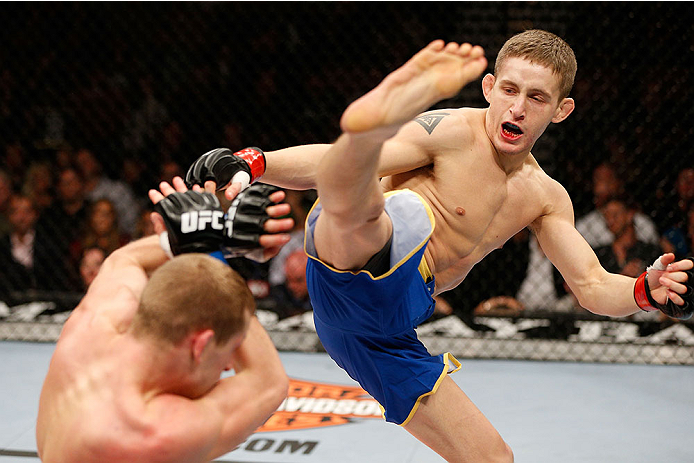 LAS VEGAS, NV - NOVEMBER 30:  (R-L) Chris Holdsworth kicks David Grant in their bantamweight final fight during The Ultimate Fighter season 18 live finale inside the Mandalay Bay Events Center on November 30, 2013 in Las Vegas, Nevada. (Photo by Josh Hedg