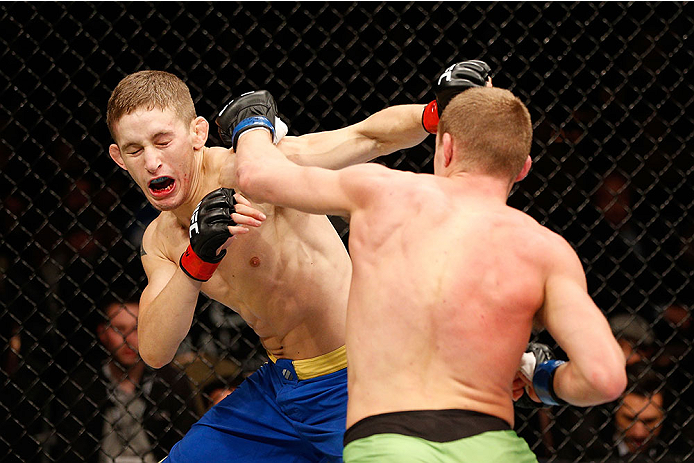 LAS VEGAS, NV - NOVEMBER 30:  (R-L) David Grant punches Chris Holdsworth in their bantamweight final fight during The Ultimate Fighter season 18 live finale inside the Mandalay Bay Events Center on November 30, 2013 in Las Vegas, Nevada. (Photo by Josh He