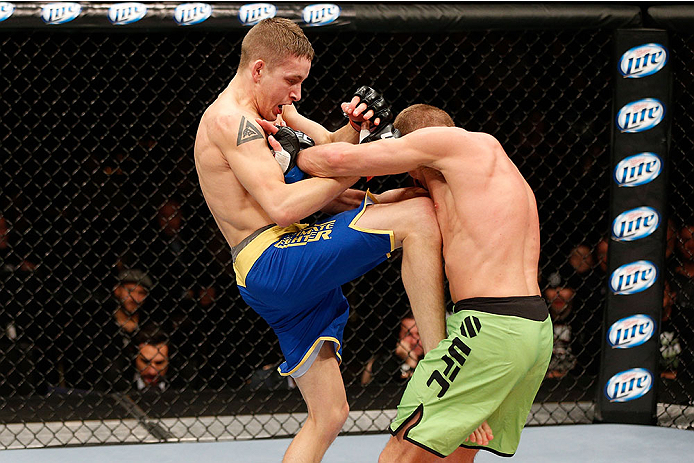 LAS VEGAS, NV - NOVEMBER 30: (L-R) Chris Holdsworth lands a knee to the body of David Grant in their bantamweight final fight during The Ultimate Fighter season 18 live finale inside the Mandalay Bay Events Center on November 30, 2013 in Las Vegas, Nevad
