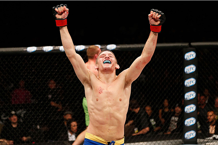 LAS VEGAS, NV - NOVEMBER 30:  Chris Holdsworth celebrates after defeating David Grant in their bantamweight final fight during The Ultimate Fighter season 18 live finale inside the Mandalay Bay Events Center on November 30, 2013 in Las Vegas, Nevada. (Pho