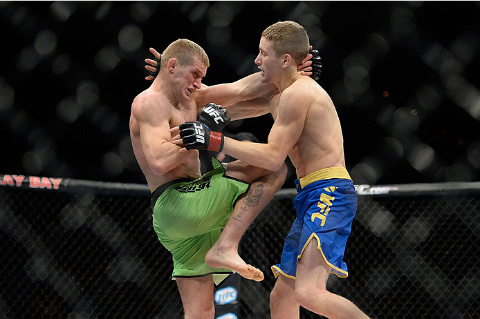 LAS VEGAS, NV - NOVEMBER 30:  (L-R) David Grant lands a knee to the body of Chris Holdsworth in their bantamweight final fight during The Ultimate Fighter season 18 live finale inside the Mandalay Bay Events Center on November 30, 2013 in Las Vegas, Nevad