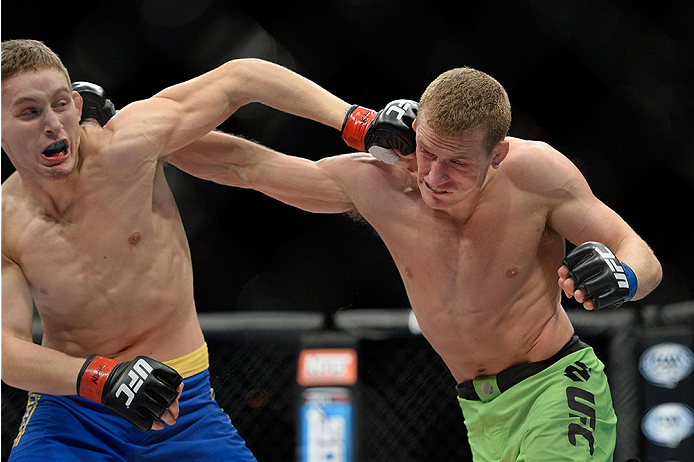 LAS VEGAS, NV - NOVEMBER 30:  (R-L) David Grant punches Chris Holdsworth in their bantamweight final fight during The Ultimate Fighter season 18 live finale inside the Mandalay Bay Events Center on November 30, 2013 in Las Vegas, Nevada. (Photo by Jeff Bo