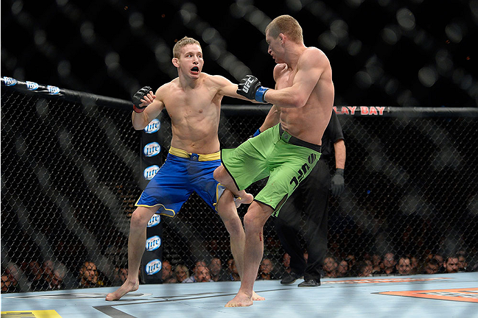 LAS VEGAS, NV - NOVEMBER 30:  (R-L) David Grant kicks Chris Holdsworth in their bantamweight final fight during The Ultimate Fighter season 18 live finale inside the Mandalay Bay Events Center on November 30, 2013 in Las Vegas, Nevada. (Photo by Jeff Bott