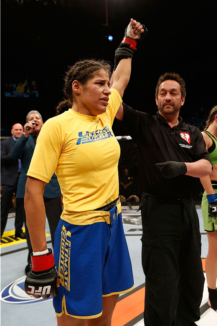 LAS VEGAS, NV - NOVEMBER 30:  Julianna Pena celebrates after defeating Jessica Rakoczy in their women's bantamweight final fight during The Ultimate Fighter season 18 live finale inside the Mandalay Bay Events Center on November 30, 2013 in Las Vegas, Nev