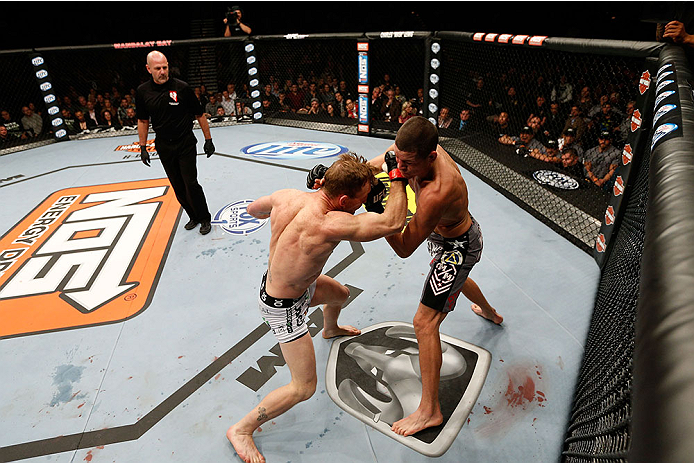 LAS VEGAS, NV - NOVEMBER 30:  (L-R) Gray Maynard punches Nate Diaz in their lightweight fight during The Ultimate Fighter season 18 live finale inside the Mandalay Bay Events Center on November 30, 2013 in Las Vegas, Nevada. (Photo by Josh Hedges/Zuffa LL