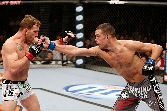 LAS VEGAS, NV - NOVEMBER 30: (R-L) Nate Diaz punches Gray Maynard in their lightweight fight during The Ultimate Fighter season 18 live finale inside the Mandalay Bay Events Center on November 30, 2013 in Las Vegas, Nevada. (Photo by Josh Hedges/Zuffa LL