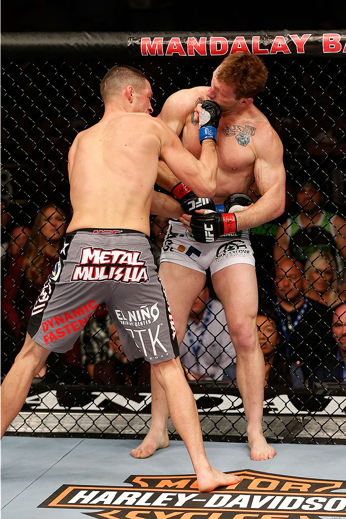 LAS VEGAS, NV - NOVEMBER 30:  (L-R) Nate Diaz punches Gray Maynard in their lightweight fight during The Ultimate Fighter season 18 live finale inside the Mandalay Bay Events Center on November 30, 2013 in Las Vegas, Nevada. (Photo by Josh Hedges/Zuffa LL