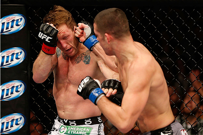 LAS VEGAS, NV - NOVEMBER 30:  (R-L) Nate Diaz punches Gray Maynard in their lightweight fight during The Ultimate Fighter season 18 live finale inside the Mandalay Bay Events Center on November 30, 2013 in Las Vegas, Nevada. (Photo by Josh Hedges/Zuffa LL