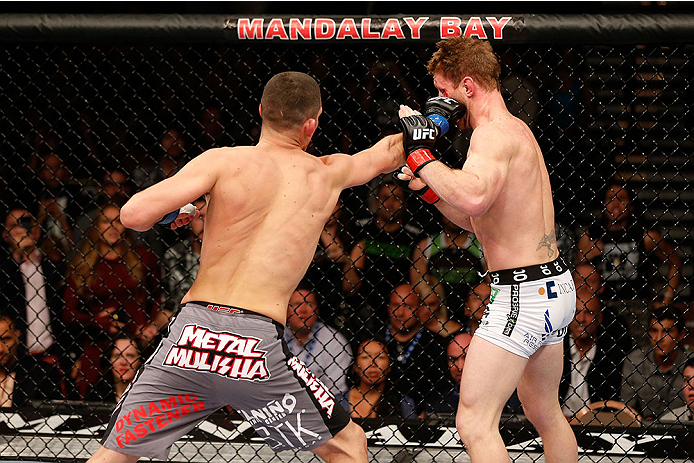 LAS VEGAS, NV - NOVEMBER 30:  (L-R) Nate Diaz punches Gray Maynard in their lightweight fight during The Ultimate Fighter season 18 live finale inside the Mandalay Bay Events Center on November 30, 2013 in Las Vegas, Nevada. (Photo by Josh Hedges/Zuffa LL