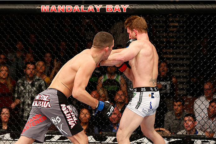 LAS VEGAS, NV - NOVEMBER 30:  (L-R) Nate Diaz punches Gray Maynard in their lightweight fight during The Ultimate Fighter season 18 live finale inside the Mandalay Bay Events Center on November 30, 2013 in Las Vegas, Nevada. (Photo by Josh Hedges/Zuffa LL