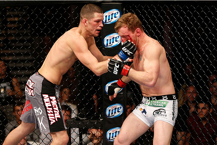 LAS VEGAS, NV - NOVEMBER 30:  (L-R) Nate Diaz punches Gray Maynard in their lightweight fight during The Ultimate Fighter season 18 live finale inside the Mandalay Bay Events Center on November 30, 2013 in Las Vegas, Nevada. (Photo by Josh Hedges/Zuffa LL