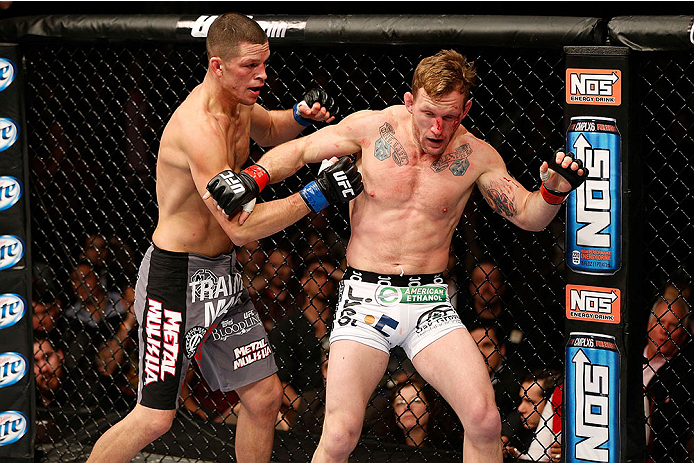 LAS VEGAS, NV - NOVEMBER 30:  (L-R) Nate Diaz punches Gray Maynard in their lightweight fight during The Ultimate Fighter season 18 live finale inside the Mandalay Bay Events Center on November 30, 2013 in Las Vegas, Nevada. (Photo by Josh Hedges/Zuffa LL