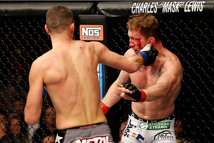 LAS VEGAS, NV - NOVEMBER 30:  (L-R) Nate Diaz punches Gray Maynard in their lightweight fight during The Ultimate Fighter season 18 live finale inside the Mandalay Bay Events Center on November 30, 2013 in Las Vegas, Nevada. (Photo by Josh Hedges/Zuffa LL