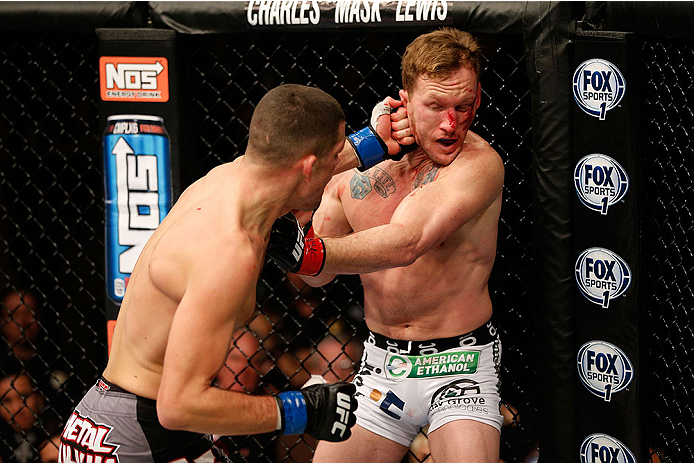 LAS VEGAS, NV - NOVEMBER 30:  (L-R) Nate Diaz punches Gray Maynard in their lightweight fight during The Ultimate Fighter season 18 live finale inside the Mandalay Bay Events Center on November 30, 2013 in Las Vegas, Nevada. (Photo by Josh Hedges/Zuffa LL