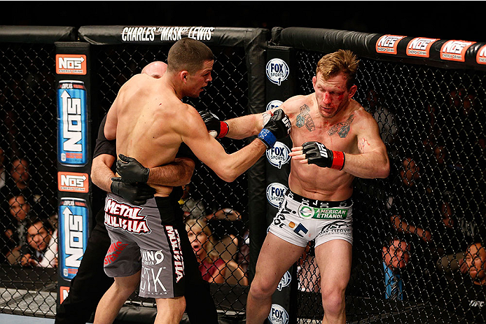 LAS VEGAS, NV - NOVEMBER 30: (L-R) Nate Diaz is called off by referee Yves Lavigne after knocking out Gray Maynard in their lightweight fight during The Ultimate Fighter season 18 live finale inside the Mandalay Bay Events Center on November 30, 2013 in