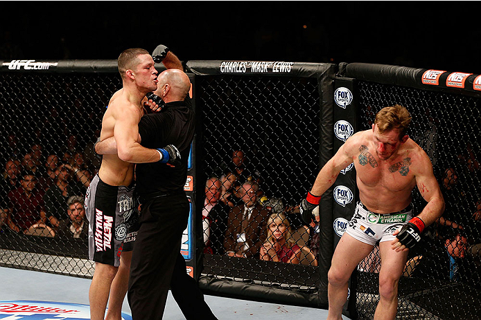LAS VEGAS, NV - NOVEMBER 30: (L-R) Nate Diaz is called off by referee Yves Lavigne after knocking out Gray Maynard in their lightweight fight during The Ultimate Fighter season 18 live finale inside the Mandalay Bay Events Center on November 30, 2013 in