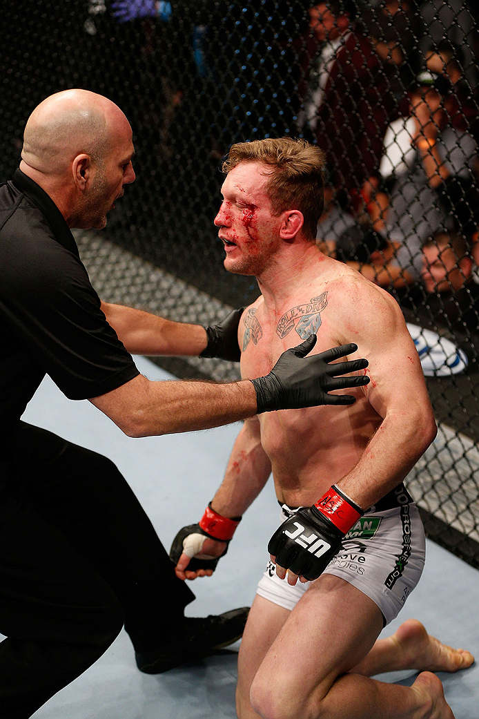 LAS VEGAS, NV - NOVEMBER 30: (R-L) Gray Maynard is talked to by referee Yves Lavigne after Maynard was knocked out by Diaz in their lightweight fight during The Ultimate Fighter season 18 live finale inside the Mandalay Bay Events Center on November 30,