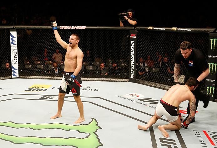 ZAGREB, CROATIA - APRIL 10:   (L-R) Damian Stasiakin celebrates his submission victory over Filip Pejic in their bantamweight bout during the UFC Fight Night event at the Arena Zagreb on April 10, 2016 in Zagreb, Croatia. (Photo by Srdjan Stevanovic/Zuffa