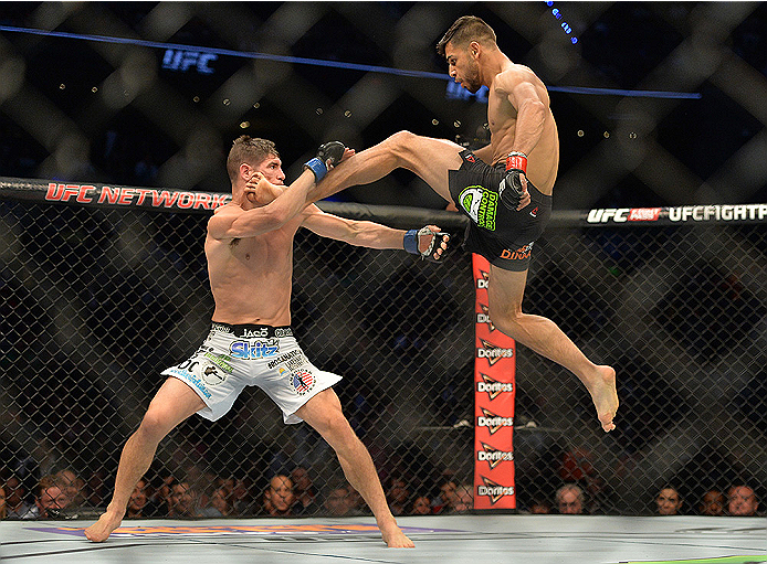MEXICO CITY, MEXICO - JUNE 13: (R-L) Yair Rodriguez of Mexico kicks Charles Rosa of the United States in their featherweight bout during the UFC 188 event at the Arena Ciudad de Mexico on June 13, 2015 in Mexico City, Mexico. (Photo by Jeff Bottari/Zuffa
