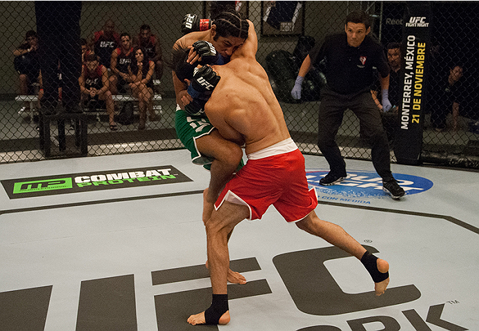 LAS VEGAS, NV - MARCH 27:  (L-R) Danny Salas knees Horacio Gutierrez during the filming of The Ultimate Fighter Latin America: Team Gastelum vs Team Escudero  on March 27, 2015 in Las Vegas, Nevada. (Photo by Brandon Magnus/Zuffa LLC/Zuffa LLC via Getty I