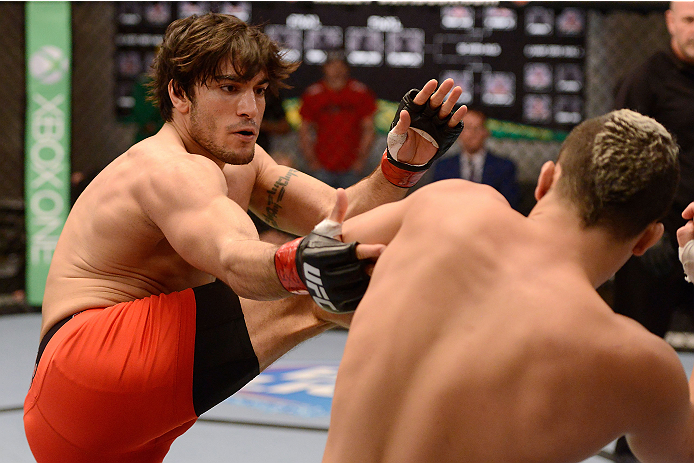 LACHUTE, CANADA - DECEMBER 6: (L-R) Team Canada fighter Elias Theodorou kicks Team Australia fighter Tyler Manawaroa in their semifinal middleweight fight during filming of The Ultimate Fighter Nations television series on December 6, 2013 in Lachute, Qu