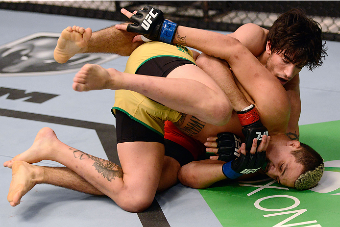 LACHUTE, CANADA - DECEMBER 6:  (L-R) Team Canada fighter Elias Theodorou controls the body of Team Australia fighter Tyler Manawaroa in their semifinal middleweight fight during filming of The Ultimate Fighter Nations television series on December 6, 2013